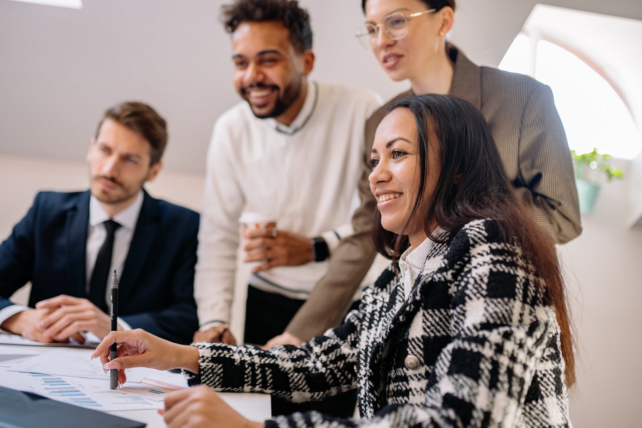 A group of professionals engaged in a collaborative business meeting, reflecting teamwork and diversity.